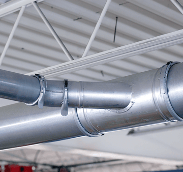 Exhaust ductwork installed in a auto repair facility for vehicle fume extraction.