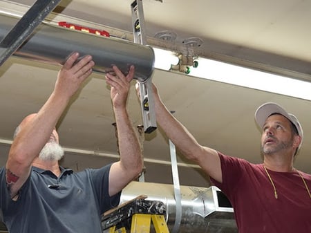 Technicians installing Nordfab ductwork.
