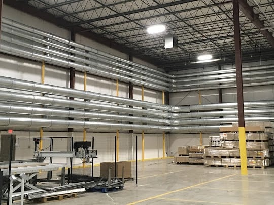 Dust collection duct shown installed in an industrial facility.