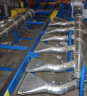 Nordfab galvanized duct dust collection system installed in an industrial facility for removing dust, smoke, and fumes.