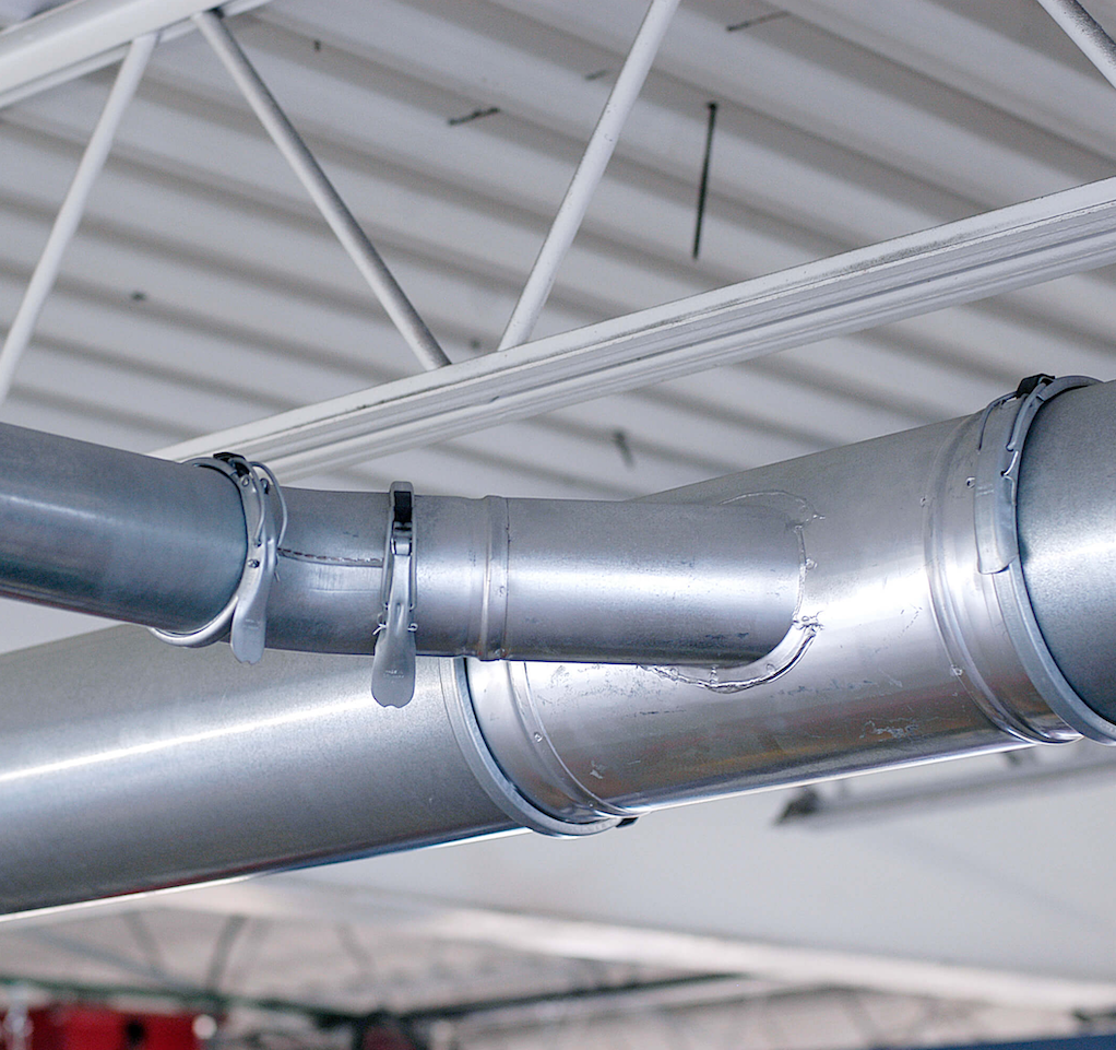 Vehicle exhaust ducting system installed in an auto repair facility to capture harmful fumes.